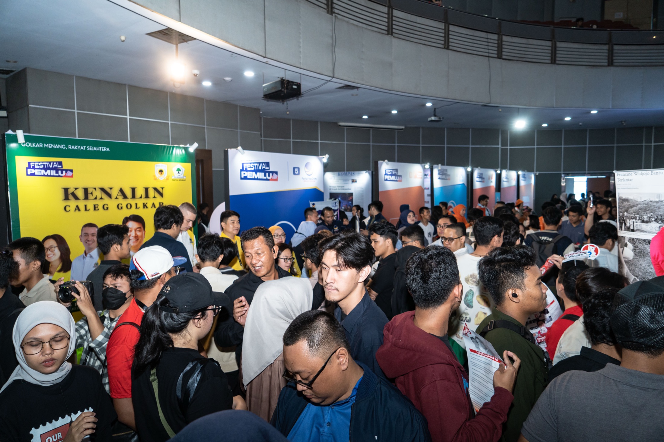 Visitors browsing political party exhibition booths at Festival Pemilu 2024