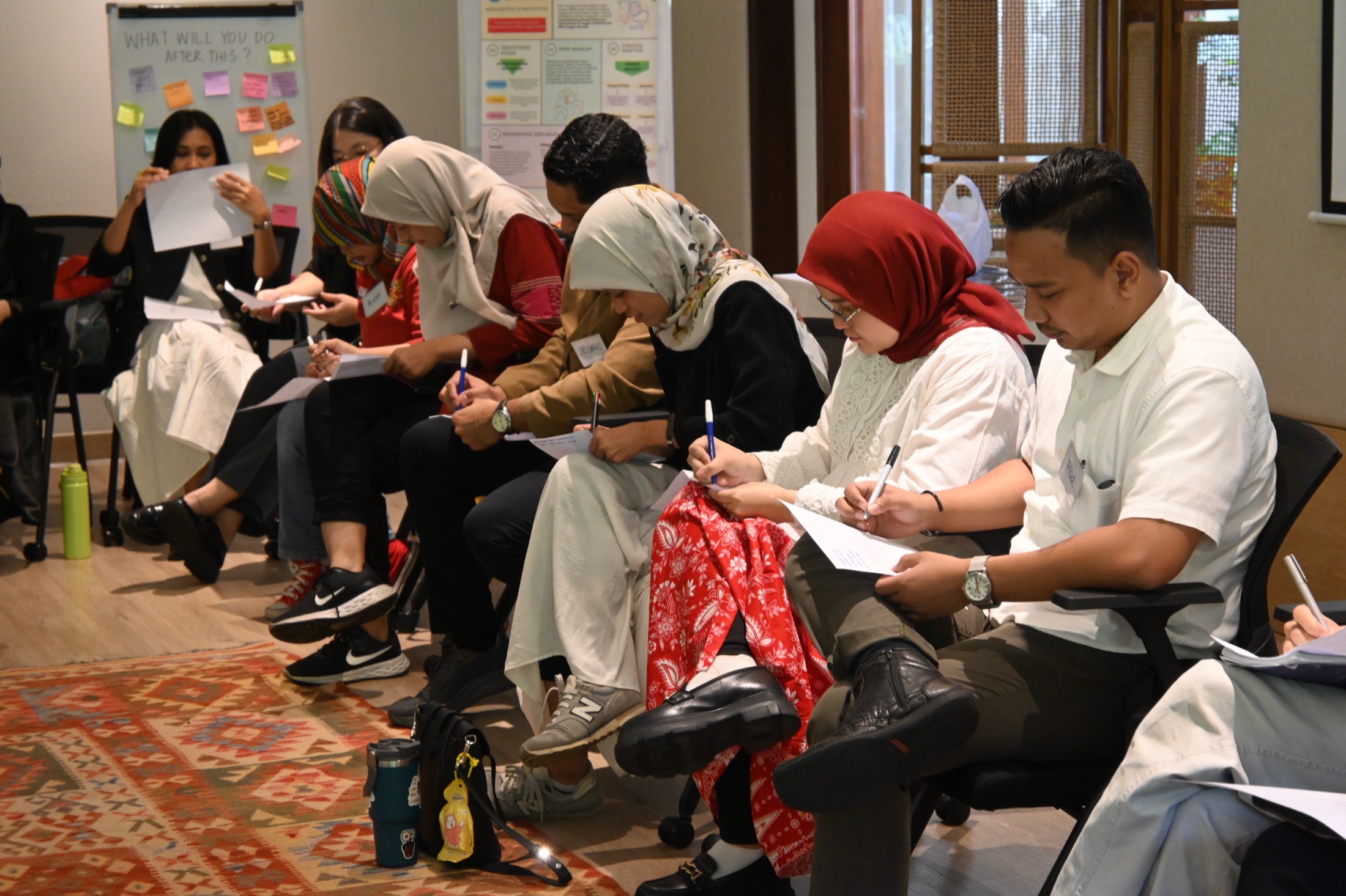 The Reformist Bootcamp cohort writing reflections during a facilitated session